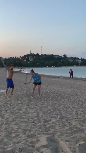 video clip of guy and girl playing bottle bash at beach in South Boston.