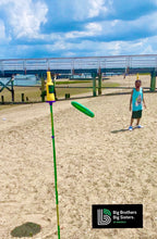 Load image into Gallery viewer, a young boy playing bottle bash at the beach
